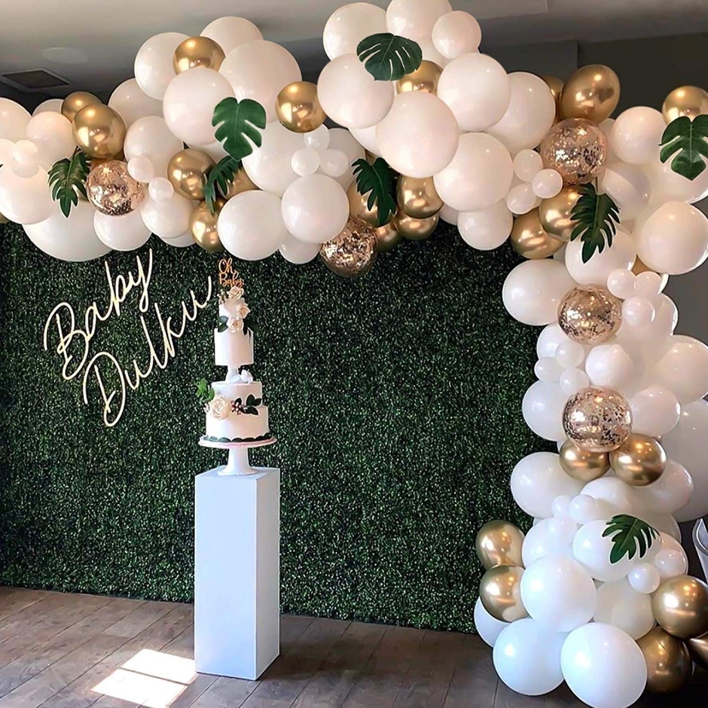 white and gold balloon garland with palm leaves